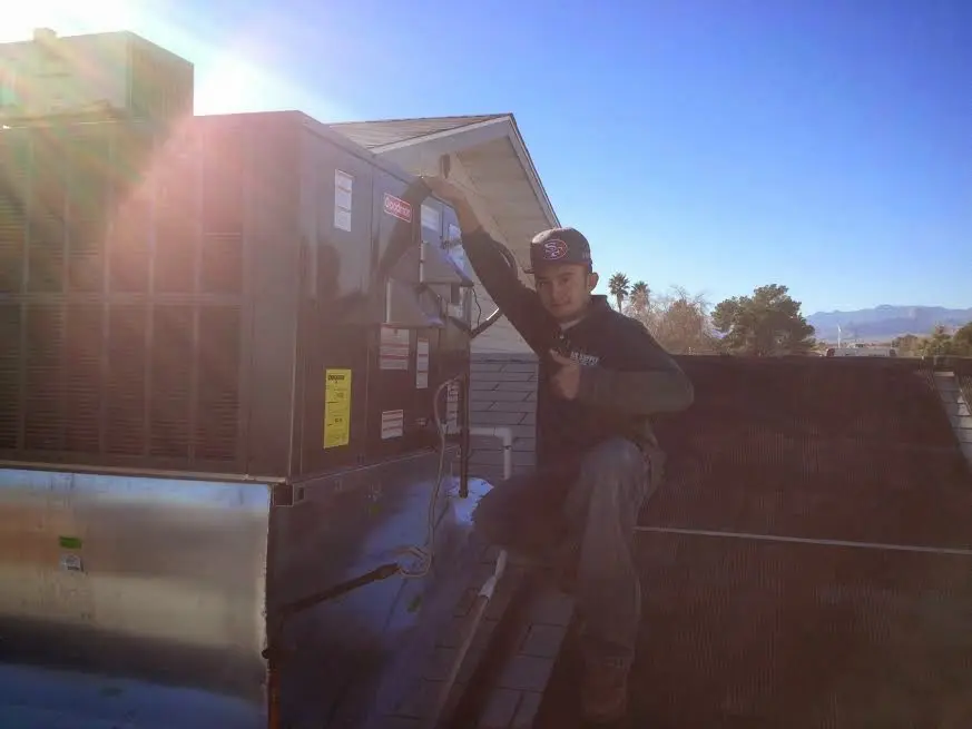 HVAC technician performing AC Tune-Up on a rooftop unit in Edwardsville